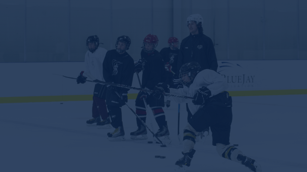 Young hockey players on the ice during a GRIT Hockey camp session